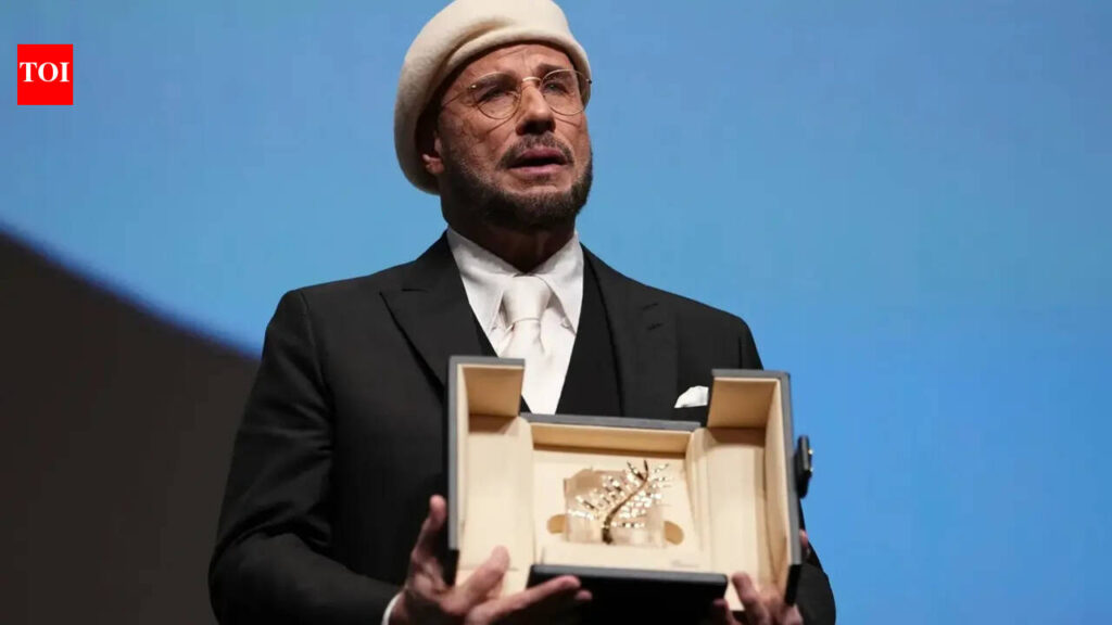 John Travolta tears up over honorary Palme d’Or at Cannes Film Festival; makes directorial debut with ‘Propeller One-Way Night Coach’
